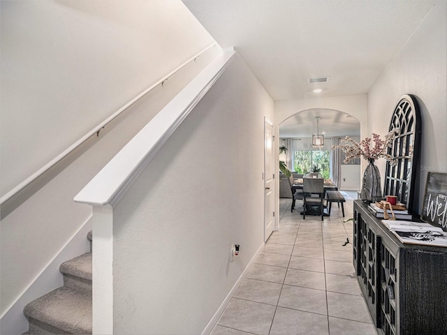17012 Oval Rum Dr, Wimauma, FL 33598 - corridor featuring arched walkways, stairs, and light tile patterned floors