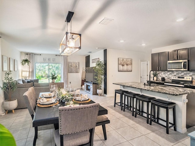 17012 Oval Rum Dr, Wimauma, FL 33598 - dining room with light tile patterned flooring and recessed lighting