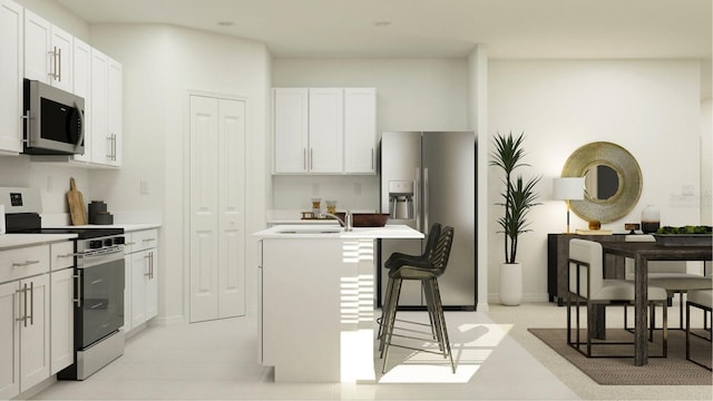 2203 Chris Dr, Winter Haven, FL 33884 - kitchen with appliances with stainless steel finishes, a center island with sink, a sink, light countertops, and white cabinetry
