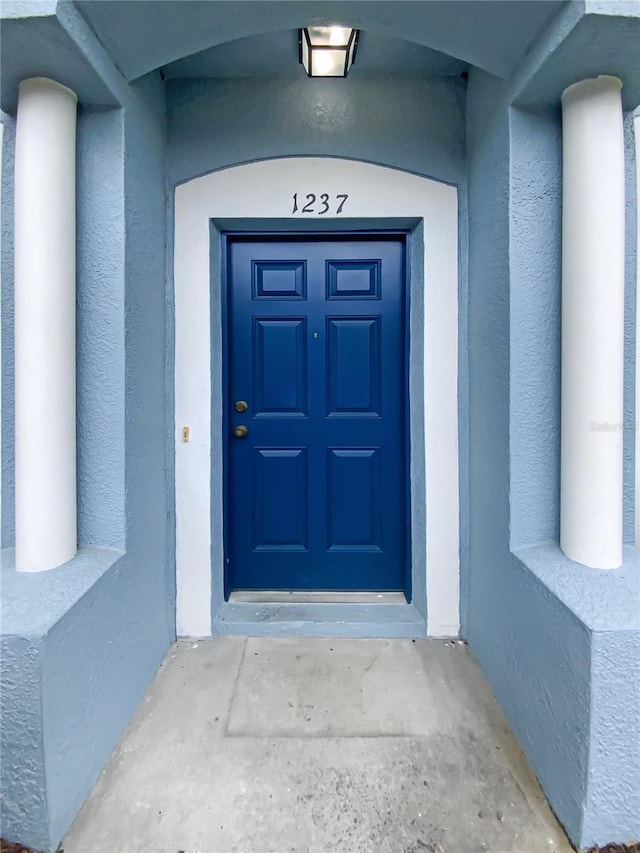 entrance to property with stucco siding