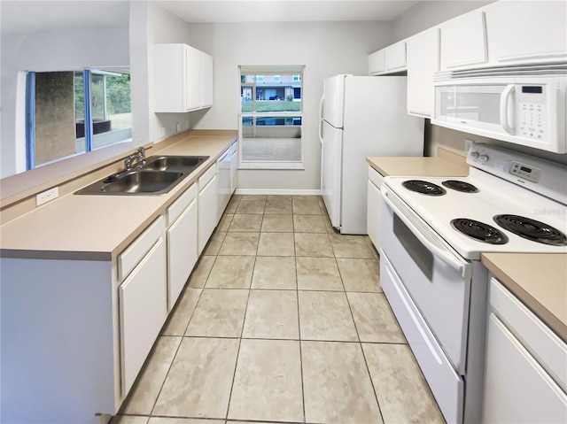 kitchen featuring white appliances, a sink, white cabinetry, and light countertops