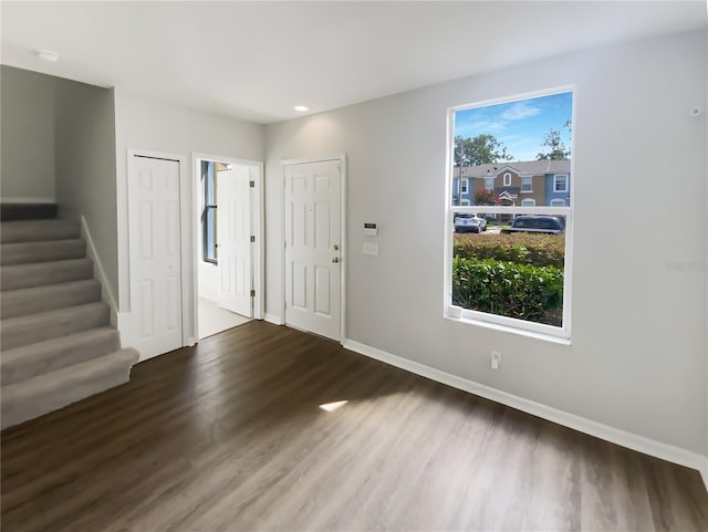 foyer entrance with wood finished floors, stairway, baseboards, and recessed lighting