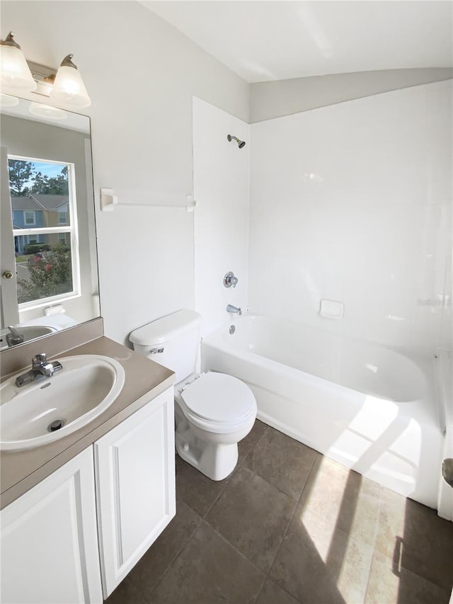 bathroom with vanity, toilet, tile patterned floors, and bathtub / shower combination