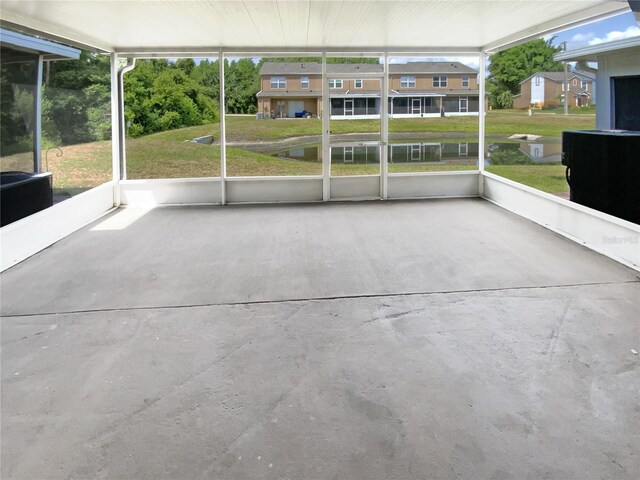 unfurnished sunroom with plenty of natural light and a water view