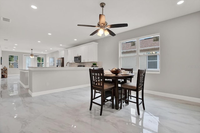 4071 45th Ave N, Saint Petersburg, FL 33714 - dining room featuring a ceiling fan, light marble finish floors, recessed lighting, and baseboards