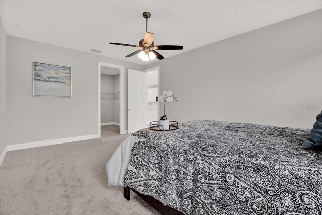 4071 45th Ave N, Saint Petersburg, FL 33714 - bedroom featuring carpet flooring, baseboards, a walk in closet, a ceiling fan, and a closet