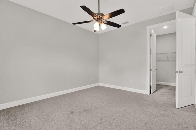 4071 45th Ave N, Saint Petersburg, FL 33714 - unfurnished bedroom with light colored carpet, baseboards, a walk in closet, ceiling fan, and a closet
