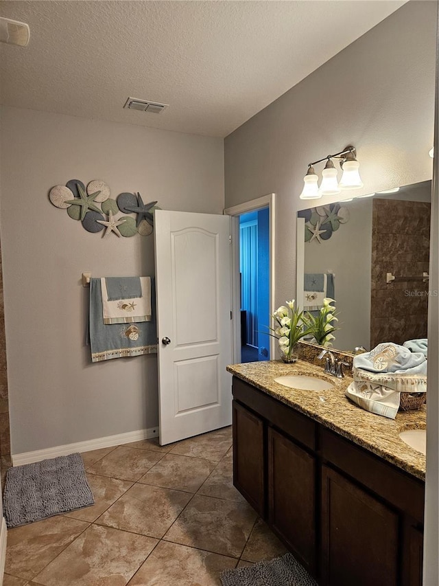 11617 Brighton Knoll Loop, Riverview, FL 33579 - full bath featuring double vanity, tile patterned floors, a textured ceiling, and baseboards