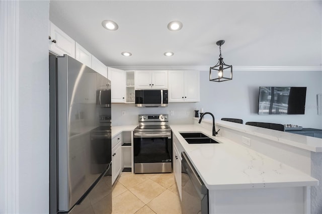 4103 Gulf Blvd Unit 107, St Pete Beach, FL 33706 - kitchen with appliances with stainless steel finishes, a sink, a peninsula, open shelves, and white cabinetry