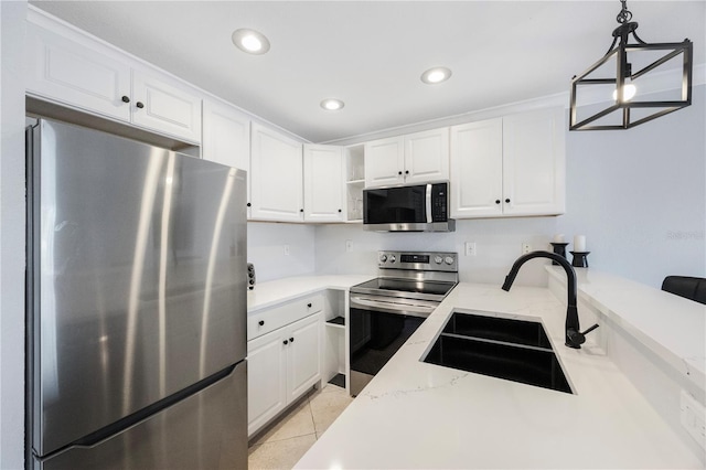 4103 Gulf Blvd Unit 107, St Pete Beach, FL 33706 - kitchen featuring stainless steel appliances, a sink, white cabinetry, light stone counters, and recessed lighting