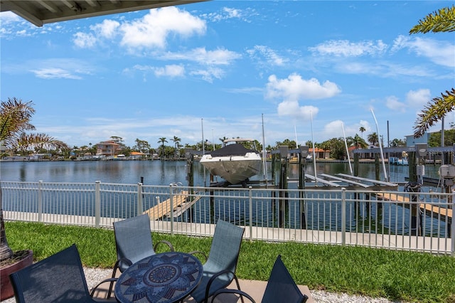 4103 Gulf Blvd Unit 107, St Pete Beach, FL 33706 - view of patio / terrace with boat lift, a boat dock, and a water view