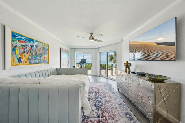 7564 Bayshore Dr Unit 302, Treasure Island, FL 33706 - living area featuring ornamental molding, wood finished floors, and ceiling fan