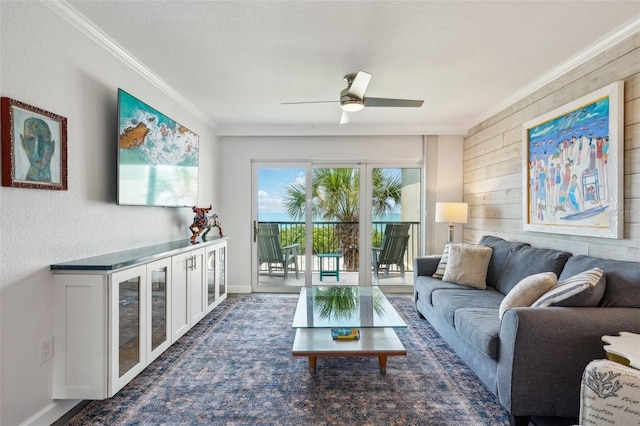 7564 Bayshore Dr Unit 302, Treasure Island, FL 33706 - living area featuring ornamental molding, wooden walls, a ceiling fan, and baseboards