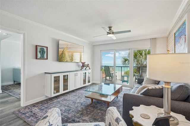 7564 Bayshore Dr Unit 302, Treasure Island, FL 33706 - living area featuring baseboards, crown molding, wood finished floors, and ceiling fan