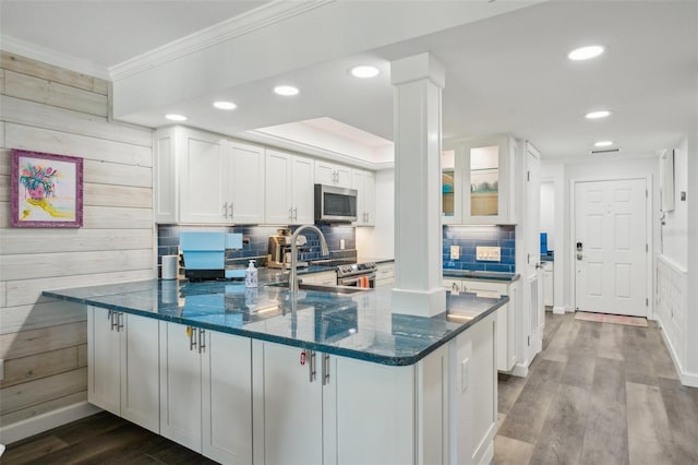 7564 Bayshore Dr Unit 302, Treasure Island, FL 33706 - kitchen with stainless steel appliances, dark stone countertops, white cabinets, crown molding, and a sink