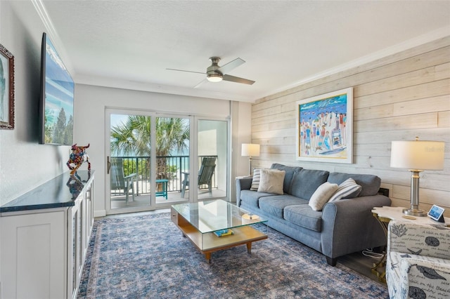 7564 Bayshore Dr Unit 302, Treasure Island, FL 33706 - living area with wooden walls, ceiling fan, ornamental molding, and wood finished floors