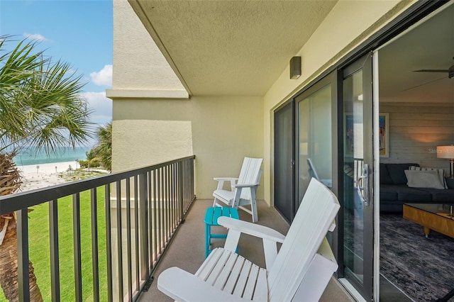7564 Bayshore Dr Unit 302, Treasure Island, FL 33706 - balcony with view of water and beach and ceiling fan