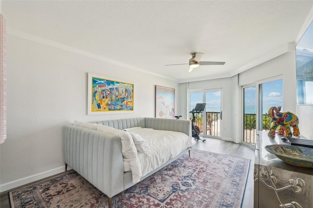 7564 Bayshore Dr Unit 302, Treasure Island, FL 33706 - bedroom featuring ornamental molding, access to exterior, baseboards, wood finished floors, and ceiling fan