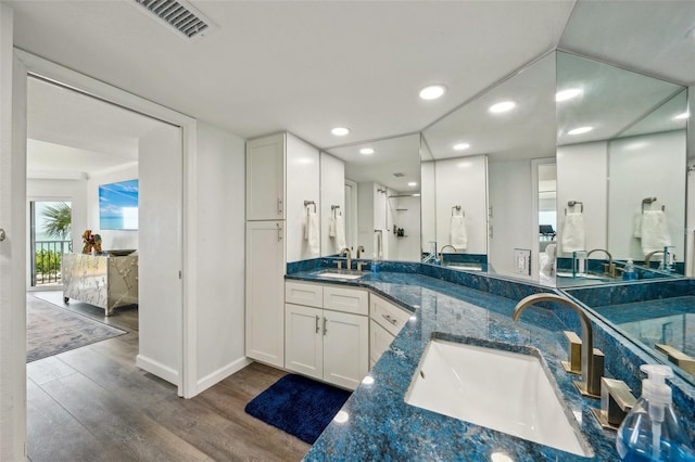 7564 Bayshore Dr Unit 302, Treasure Island, FL 33706 - ensuite bathroom with wood finished floors, double vanity, recessed lighting, and baseboards