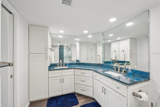 7564 Bayshore Dr Unit 302, Treasure Island, FL 33706 - bathroom with recessed lighting, wood finished floors, a stall shower, and double vanity