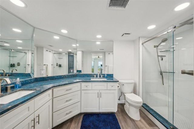7564 Bayshore Dr Unit 302, Treasure Island, FL 33706 - bathroom with a shower stall, wood finished floors, recessed lighting, and toilet