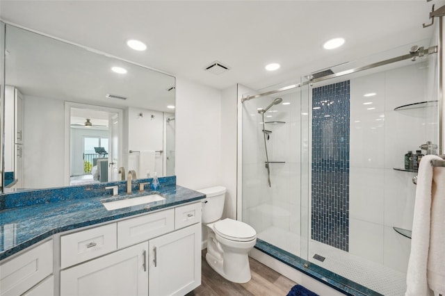 7564 Bayshore Dr Unit 302, Treasure Island, FL 33706 - full bath with a stall shower, wood finished floors, toilet, ceiling fan, and recessed lighting