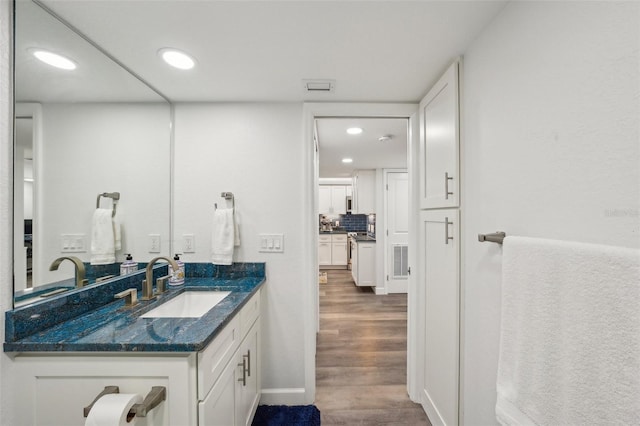 7564 Bayshore Dr Unit 302, Treasure Island, FL 33706 - bathroom with vanity, wood finished floors, recessed lighting, baseboards, and backsplash