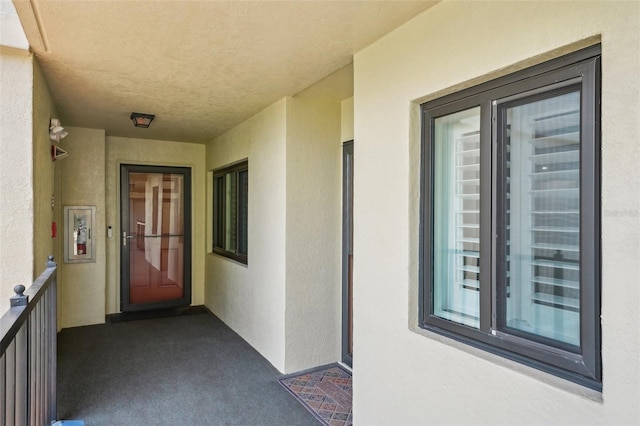 7564 Bayshore Dr Unit 302, Treasure Island, FL 33706 - property entrance with a balcony and stucco siding