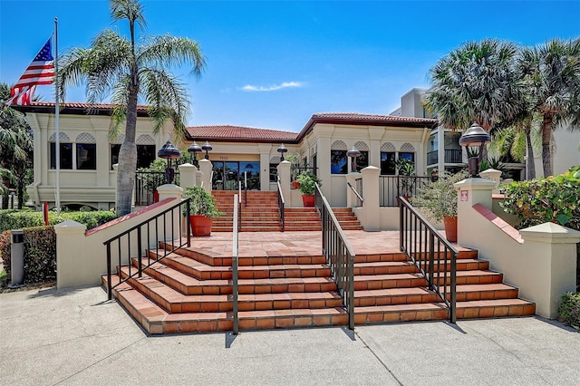 7564 Bayshore Dr Unit 302, Treasure Island, FL 33706 - mediterranean / spanish-style house with a chimney, stairway, and a tile roof