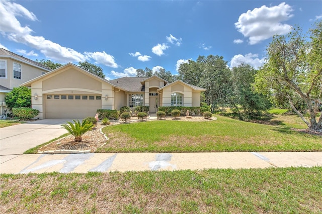 view of front of property featuring stucco siding, a garage, a front lawn, and driveway