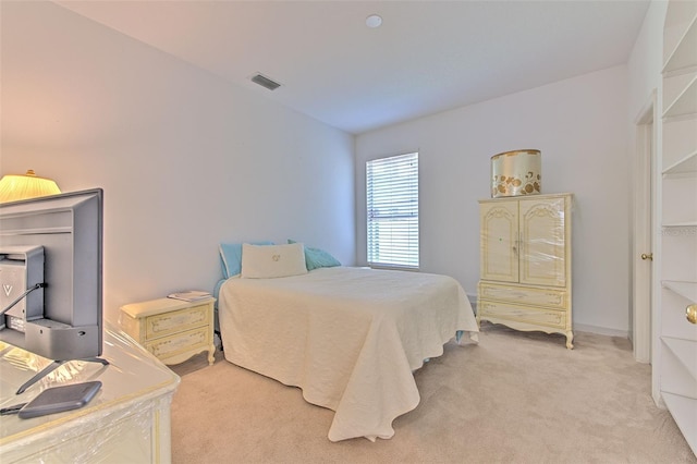 bedroom featuring light carpet