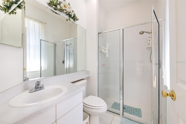 bathroom with a shower stall, toilet, and vanity