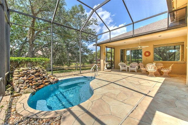outdoor pool with a patio, ceiling fan, and a lanai