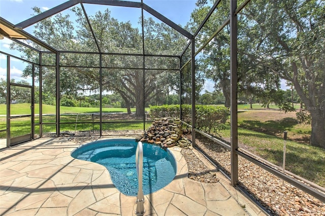 swimming pool with a patio area, glass enclosure, and a yard