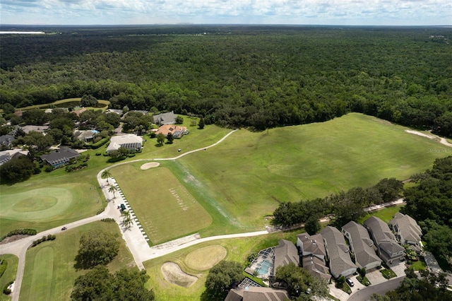 aerial view of property's location with a forest, nearby suburban area, and a golf club