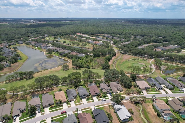 aerial view of property and surrounding area with a large body of water and nearby suburban area