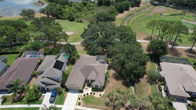 aerial view of residential area with a golf club and a large body of water