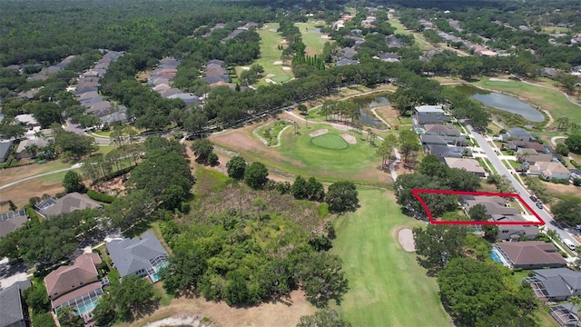 aerial overview of property's location featuring nearby suburban area, a local golf course, a nearby body of water, and property parcel outlined