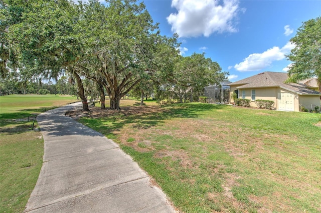 view of green lawn with an attached garage