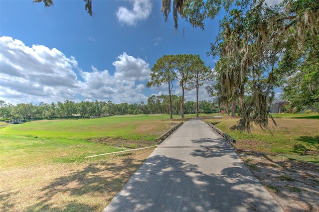 view of road featuring view of scattered trees and view of golf course