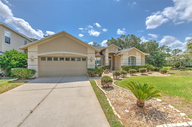 view of front of property with stucco siding, driveway, a garage, and a front lawn