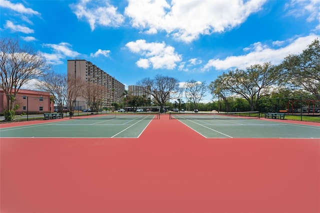 7075 Sunset Dr S, South Pasadena, FL 33707 - view of tennis court with community basketball court and fence