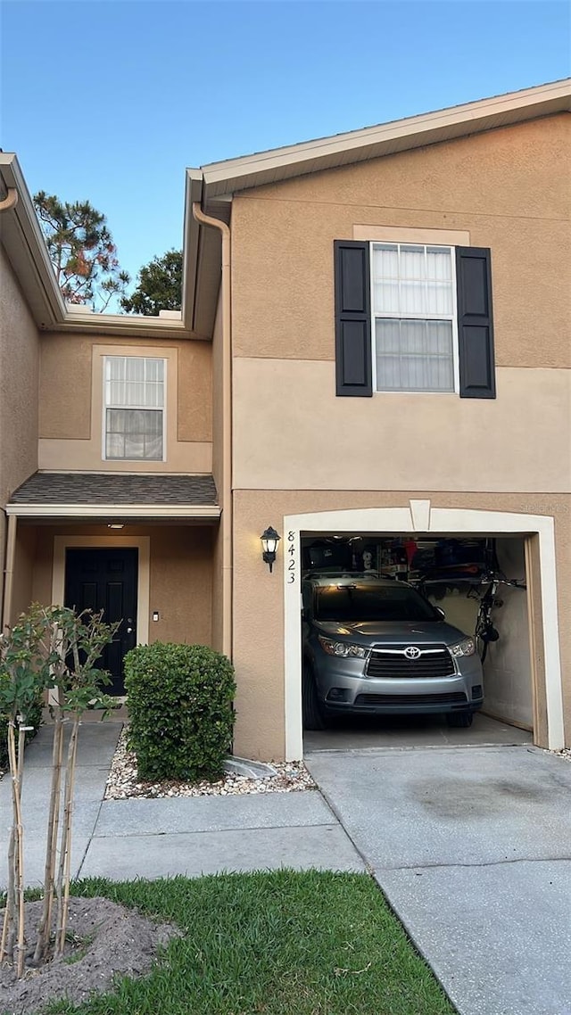 8423 Edgewater Place Blvd, Tampa, FL 33615 - view of front facade featuring stucco siding, an attached garage, and concrete driveway