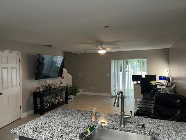 8423 Edgewater Place Blvd, Tampa, FL 33615 - living room with a ceiling fan, a desk, baseboards, and wood finished floors