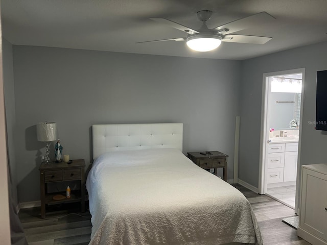 8423 Edgewater Place Blvd, Tampa, FL 33615 - bedroom featuring light wood-style flooring, ensuite bath, baseboards, and a ceiling fan
