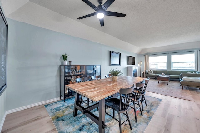 2003 Cordova Grn, Seminole, FL 33777 - dining space with lofted ceiling, light wood finished floors, a ceiling fan, a textured ceiling, and baseboards