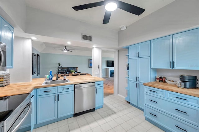 2003 Cordova Grn, Seminole, FL 33777 - kitchen with wooden counters, appliances with stainless steel finishes, blue cabinetry, and recessed lighting