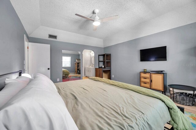 2003 Cordova Grn, Seminole, FL 33777 - bedroom with a textured ceiling, wood finished floors, lofted ceiling, arched walkways, and a ceiling fan