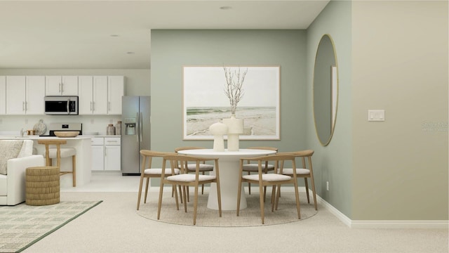 dining room with light colored carpet and baseboards