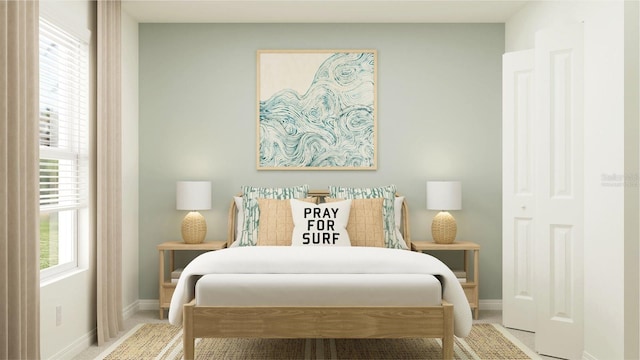 bedroom featuring baseboards and light carpet